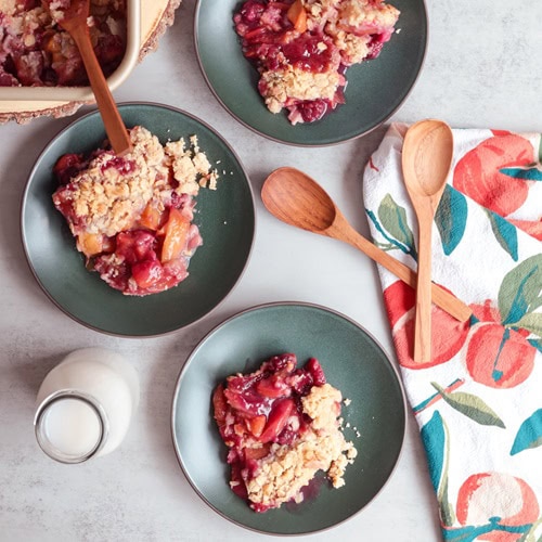 Blackberry peach crisp on small green plates